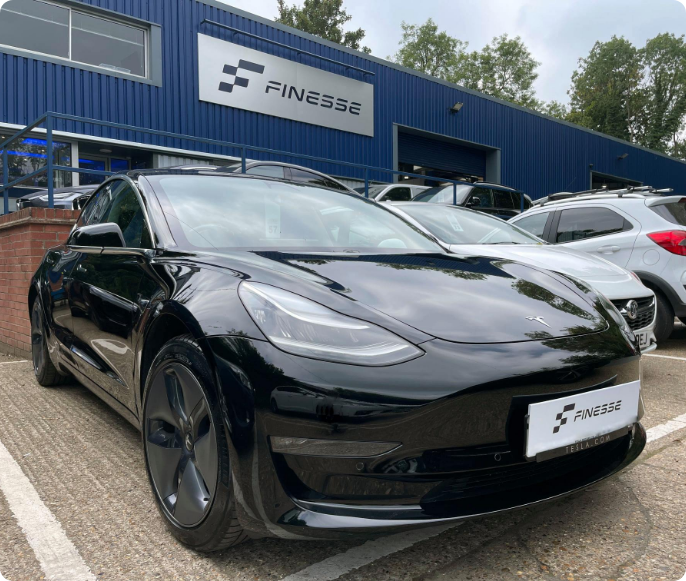Finesse Tesla Image Finesse | an image of a Tesla in black in our show room