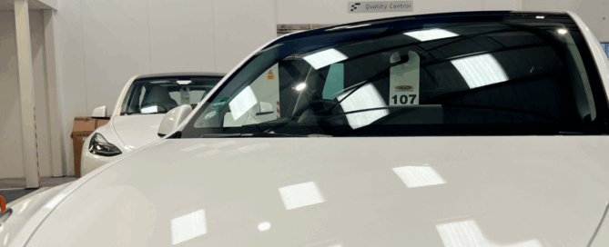 The image shows a white Tesla at Finesse approved body shop