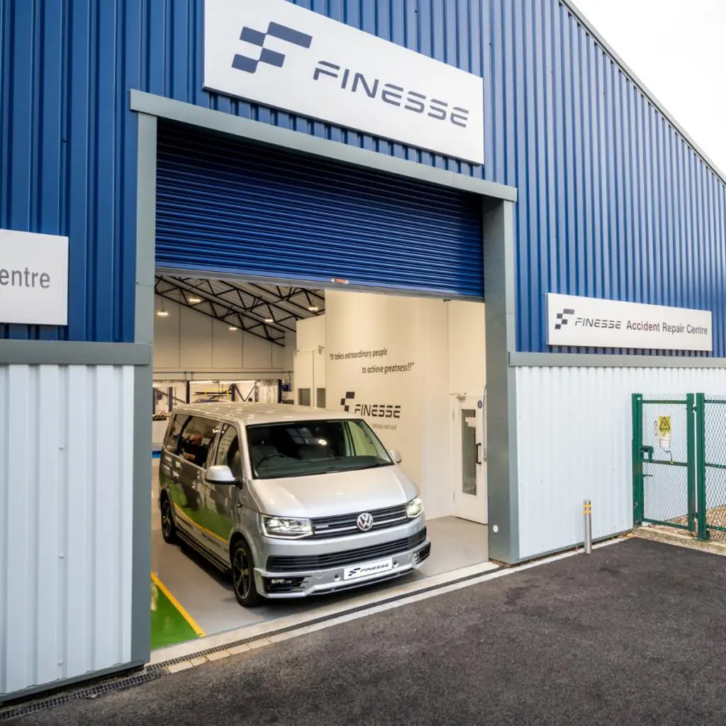 A technician repairing a van at Finesse approved Volkswagen body shop