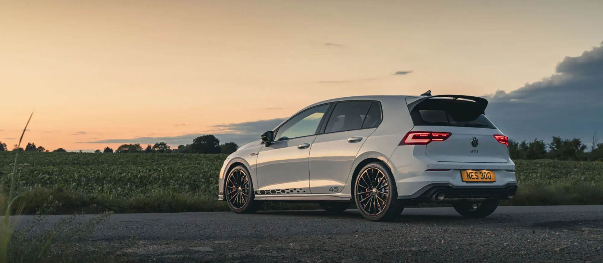 FN Volkswagen Approval Image Finesse | an image of a Volkswagen parked on the road with a sunset in the background
