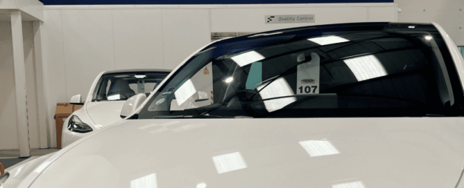 The image shows a white Tesla at Finesse approved body shop