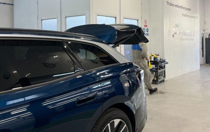 Finesse Redhill showing a blue Volkswagen car to repair.