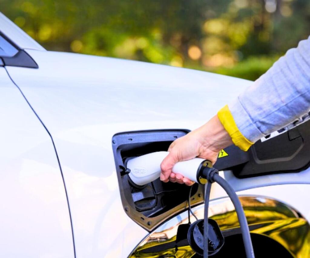 A person charging an AION vehicle